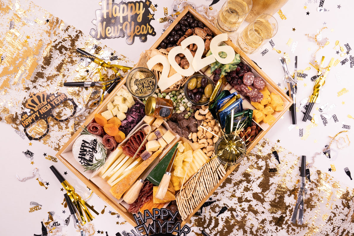 Gourmet snack platter with New Year's decorations on a festive background